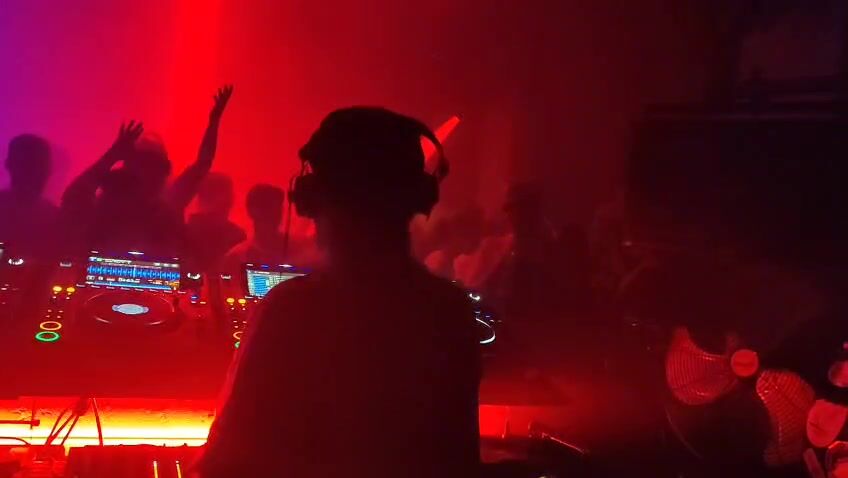 View from the DJ booth at fabric across a packed, smoky dance floor