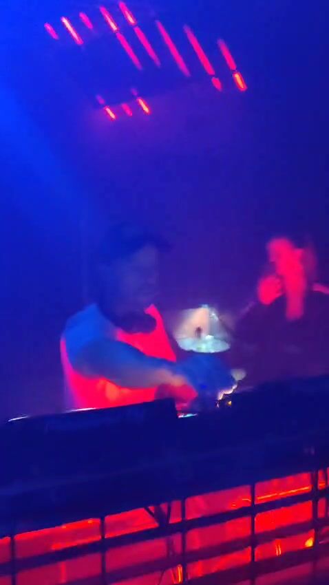 Theon Bower playing under blue and red stage lights